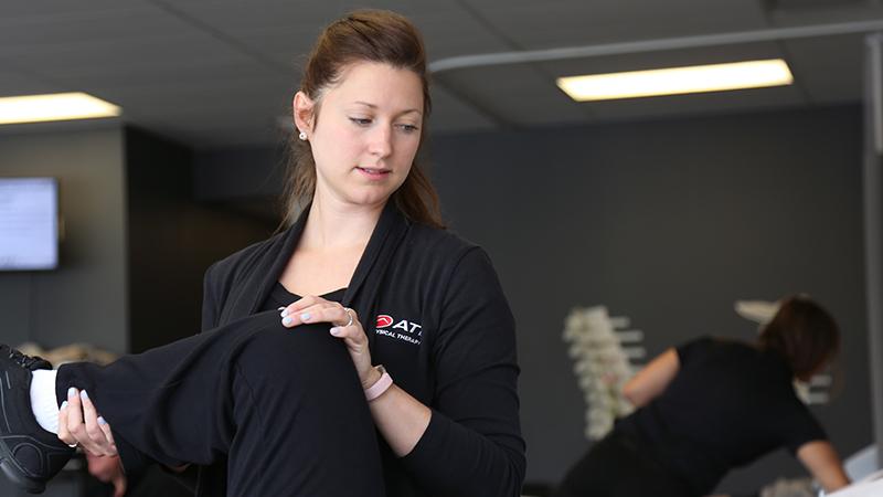 Physical therapist assessing a patient