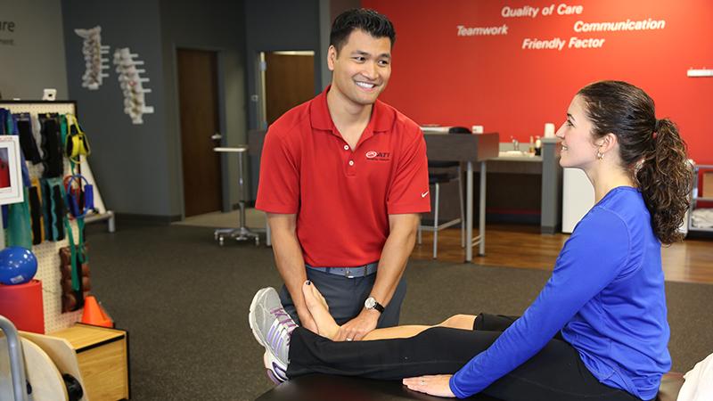 ATI therapist with a patient, examining leg