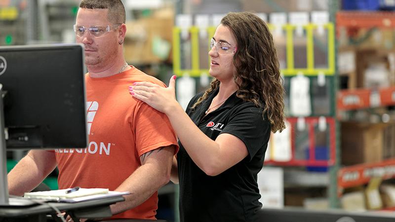 Physical therapist with an employee onsite