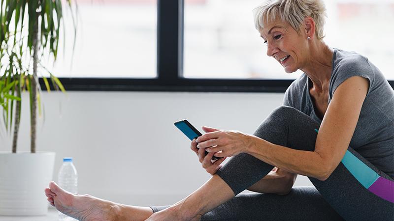 Patient looking at app while doing exercises