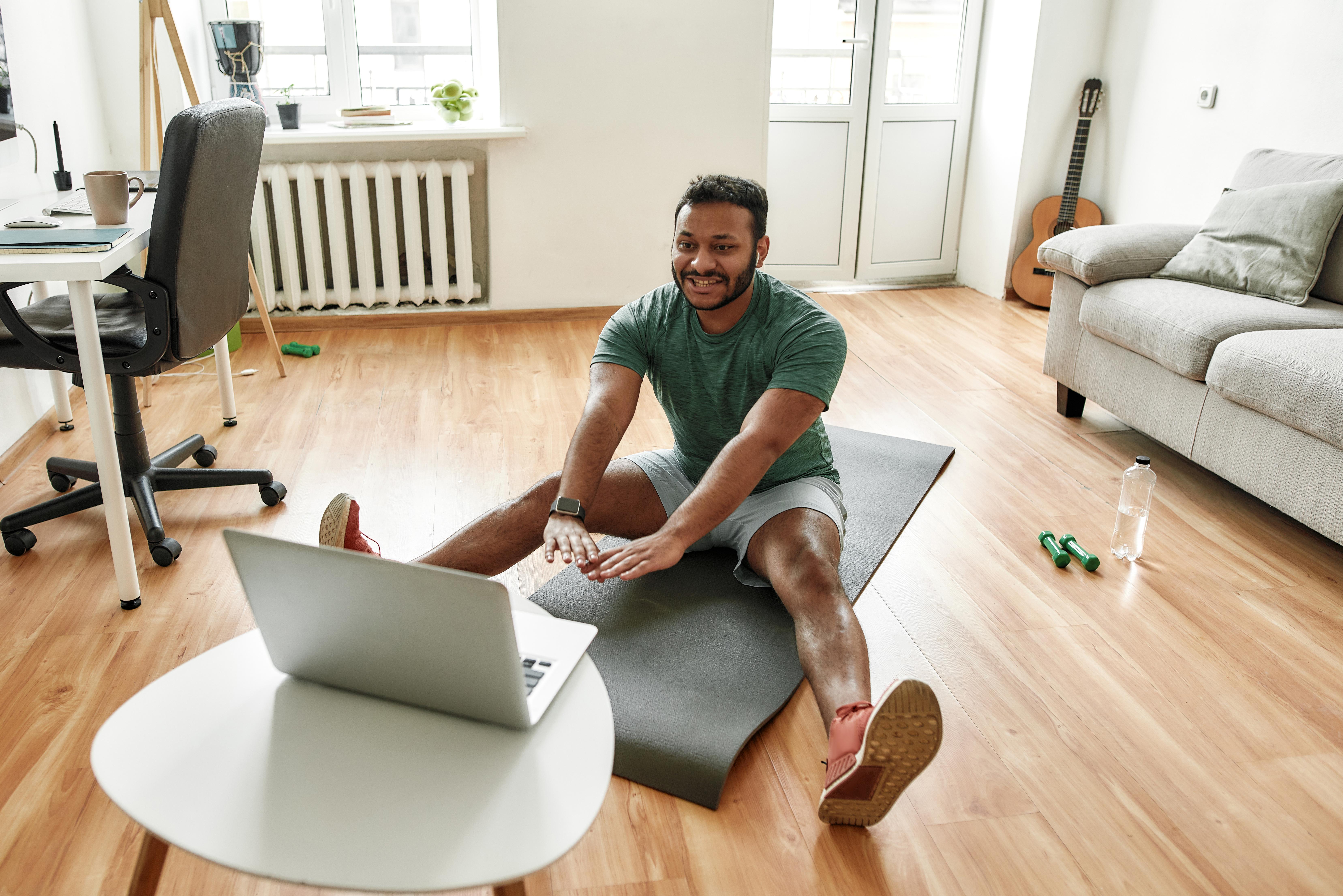 Man doing remote physical therapy at home